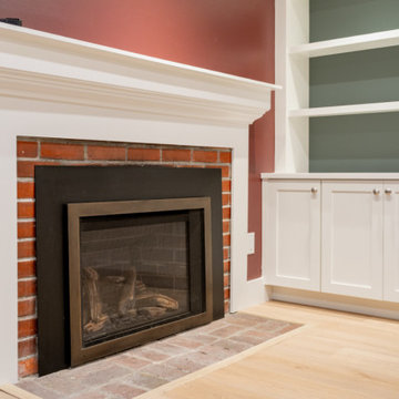 Basement Living Room with Brick Fireplace and Custom Built-in Shelving