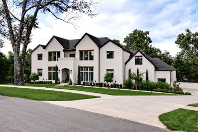 Large transitional white three-story brick house exterior photo in Other with a shingle roof and a black roof