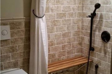 Example of a small transitional 3/4 beige tile and stone tile bamboo floor and beige floor bathroom design with a wall-mount toilet and beige walls