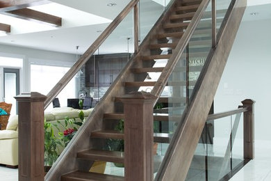 Photo of a contemporary wood straight staircase in Edmonton with open risers.