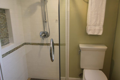Small trendy white tile porcelain tile, beige floor and single-sink walk-in shower photo in San Francisco with a two-piece toilet and green walls