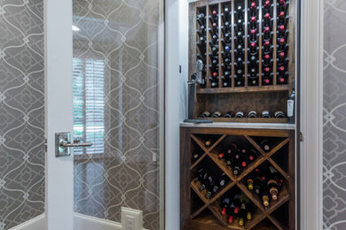 Example of a small transitional medium tone wood floor wine cellar design in Dallas