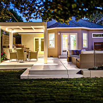 Inviting Raised Patio with Custom Pergola and Gate