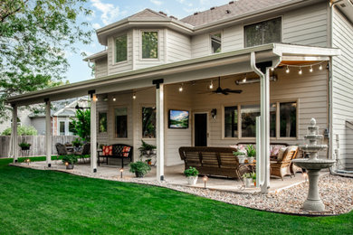 Inspiration for a mid-sized craftsman concrete back porch remodel in Denver