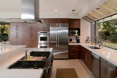 Inspiration for a modern l-shaped eat-in kitchen in Sacramento with an undermount sink, flat-panel cabinets, dark wood cabinets, stainless steel appliances and with island.