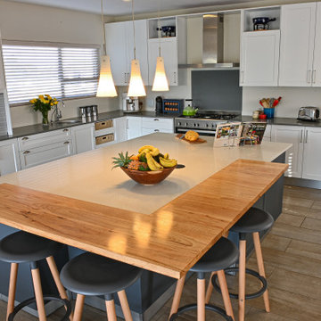 The open plan shaker-style grey & white kitchen