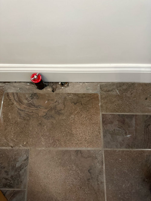 How to fill gaps in tile around a pipe?