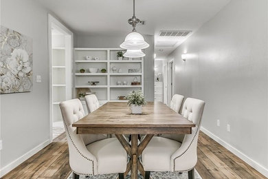 Example of a small arts and crafts dark wood floor dining room design in Oklahoma City with gray walls