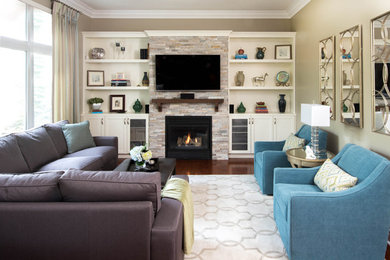 Inspiration for a mid-sized transitional open concept family room in Toronto with beige walls, dark hardwood floors, a standard fireplace and a built-in media wall.