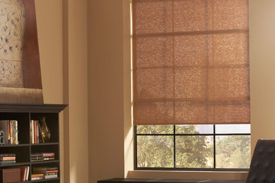 Example of a large trendy freestanding desk light wood floor and brown floor study room design in DC Metro with beige walls