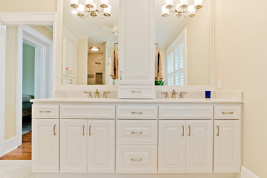 Example of a large transitional master gray tile and porcelain tile porcelain tile alcove shower design in Miami with raised-panel cabinets, white cabinets, a two-piece toilet, beige walls, an undermount sink and quartz countertops