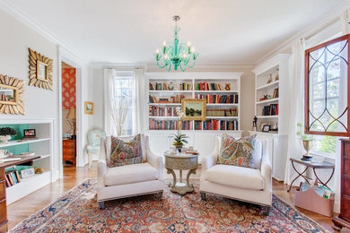 Traditional enclosed family room in Richmond with a library, beige walls and medium hardwood floors.