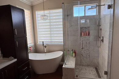 Example of a mid-sized trendy master gray tile and marble tile double-sink, vinyl floor and red floor bathroom design in Orange County with shaker cabinets, dark wood cabinets, an undermount sink, quartzite countertops, a hinged shower door, white countertops, a built-in vanity, a one-piece toilet and beige walls