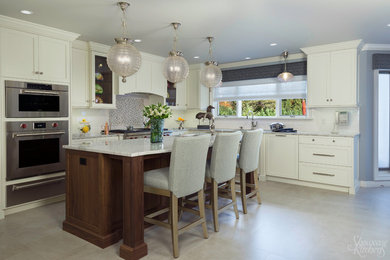 Large l-shaped porcelain tile eat-in kitchen photo in New York with an undermount sink, shaker cabinets, white cabinets, quartz countertops, white backsplash, ceramic backsplash, paneled appliances and an island