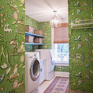 This is an example of a medium sized classic single-wall separated utility room in Atlanta with a side by side washer and dryer, beige floors, raised-panel cabinets, white cabinets, multi-coloured walls and travertine flooring.