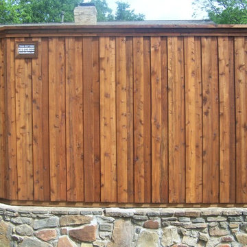 Cap Rail Board on Board Cedar Fence Stone Retaining Wall