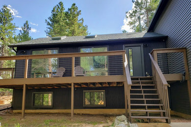 Example of a mountain style home design design in Denver