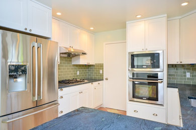 Inspiration for a mid-sized modern u-shaped porcelain tile and orange floor eat-in kitchen remodel in San Francisco with an undermount sink, shaker cabinets, white cabinets, granite countertops, gray backsplash, subway tile backsplash, stainless steel appliances, a peninsula and blue countertops