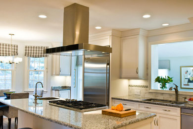 Example of a mid-sized classic l-shaped medium tone wood floor kitchen design in Boston with an island