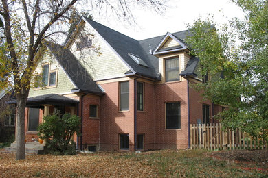 Mid-sized victorian two-story mixed siding exterior home idea in Denver with a shingle roof