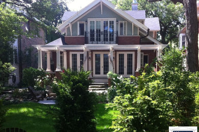 Example of a mid-sized green two-story wood exterior home design in Chicago