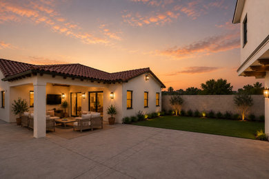Inspiration for a mid-sized mediterranean beige one-story stucco house exterior remodel in Los Angeles with a hip roof, a tile roof and a red roof