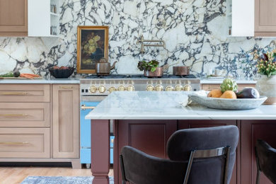 Inspiration for a mid-sized timeless medium tone wood floor kitchen remodel in Kansas City with a farmhouse sink, flat-panel cabinets, white cabinets, quartzite countertops, white backsplash, marble backsplash, colored appliances, an island and white countertops