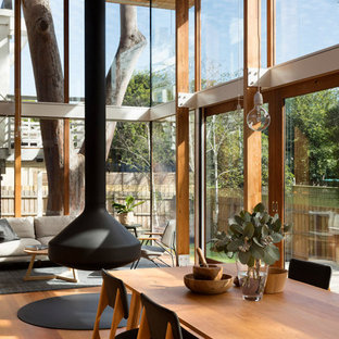 Design ideas for a contemporary open plan dining in Melbourne with medium hardwood floors and orange floor.