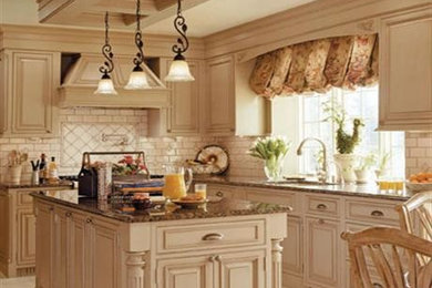 Example of a mid-sized classic u-shaped porcelain tile and white floor eat-in kitchen design in Orlando with an undermount sink, raised-panel cabinets, beige cabinets, granite countertops, white backsplash, subway tile backsplash, stainless steel appliances and an island