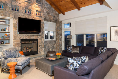 Inspiration for a mid-sized country open concept family room in New York with grey walls, carpet, a standard fireplace, a stone fireplace surround and a built-in media wall.