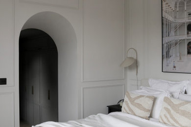 This is an example of a medium sized scandinavian master bedroom in Edinburgh with beige walls, light hardwood flooring, no fireplace and beige floors.