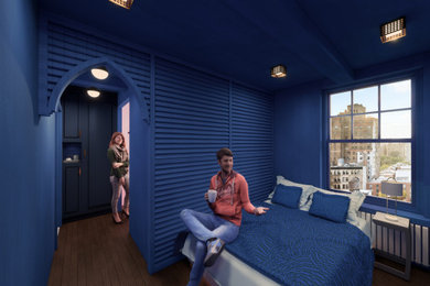 Modelo de dormitorio principal contemporáneo pequeño con paredes azules y suelo de madera pintada
