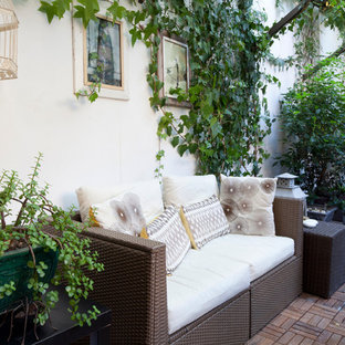 Inspiration for a traditional patio in Milan with brick pavers.