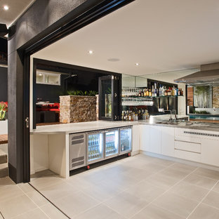 Design ideas for a large contemporary backyard patio in Melbourne with an outdoor kitchen and a roof extension.