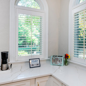 Bright Corner Coffee Station with Quartz Countertops and Arched Windows