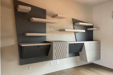 Example of a trendy built-in desk wall paneling study room design in Phoenix
