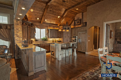Open concept kitchen - contemporary l-shaped light wood floor and brown floor open concept kitchen idea in Wichita with an undermount sink, granite countertops, stainless steel appliances and an island