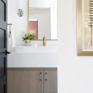 Bathroom - contemporary blue floor bathroom idea in Orange County with flat-panel cabinets, brown cabinets, white walls, a vessel sink and white countertops