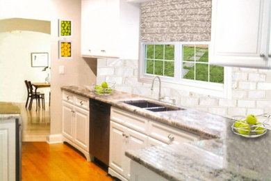 Inspiration for a timeless galley medium tone wood floor and brown floor enclosed kitchen remodel with a double-bowl sink, raised-panel cabinets, white cabinets, granite countertops, white backsplash, stone slab backsplash, stainless steel appliances, an island and gray countertops