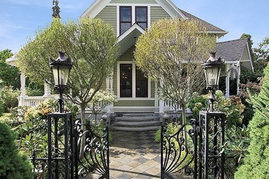Victorian green two-story wood exterior home idea in Seattle