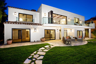 Large tuscan white two-story stucco flat roof photo in Houston