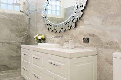 Mid-sized traditional master bathroom in Melbourne with shaker cabinets, white cabinets, an open shower, a one-piece toilet, gray tile, porcelain tile, grey walls, porcelain floors, a drop-in sink, engineered quartz benchtops, grey floor, an open shower and white benchtops.