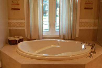 Example of a transitional beige tile and porcelain tile porcelain tile bathroom design in Denver with beige walls and marble countertops