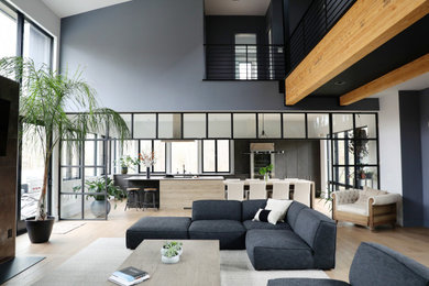 Inspiration for a large contemporary open concept light wood floor and beige floor living room remodel in New York with gray walls, a standard fireplace, a tile fireplace and a wall-mounted tv