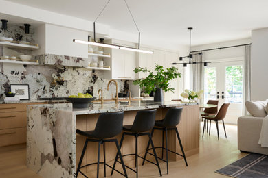 Kitchen - contemporary l-shaped light wood floor and beige floor kitchen idea in Toronto with flat-panel cabinets, light wood cabinets, multicolored backsplash, stainless steel appliances, an island and multicolored countertops