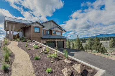 Huge contemporary brown two-story wood house exterior idea in Other with a hip roof and a metal roof