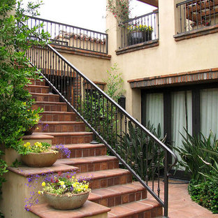 Inspiration for a medium sized straight metal railing staircase in San Francisco with terracotta treads and terracotta risers.