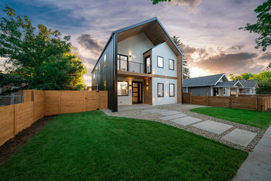 Mid-sized transitional two-storey black house exterior in Denver with metal siding, a gable roof and a metal roof.