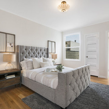 Contemporary/Eclectic bedroom with a shaker white door and wood floors