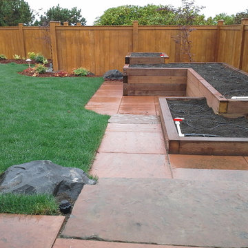 Raised garden beds and stone patio